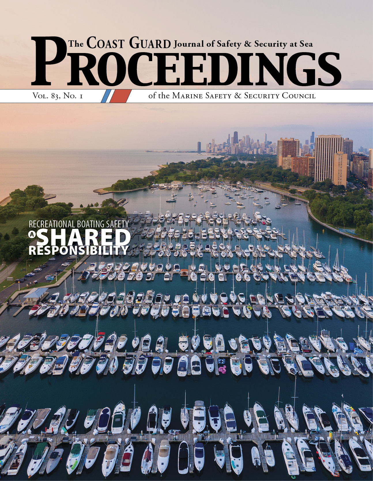 Proceedings Magazine cover:  The sun is rising on an aerial view of Chicago's Montrose Harbor Marina looking toward open water. The tall buildings of the city's skyline are visible on the right. The marina has seven docks and the slips on either side of each dock are filled with recreational watercraft. There are several boats anchored just past the furthest dock.
